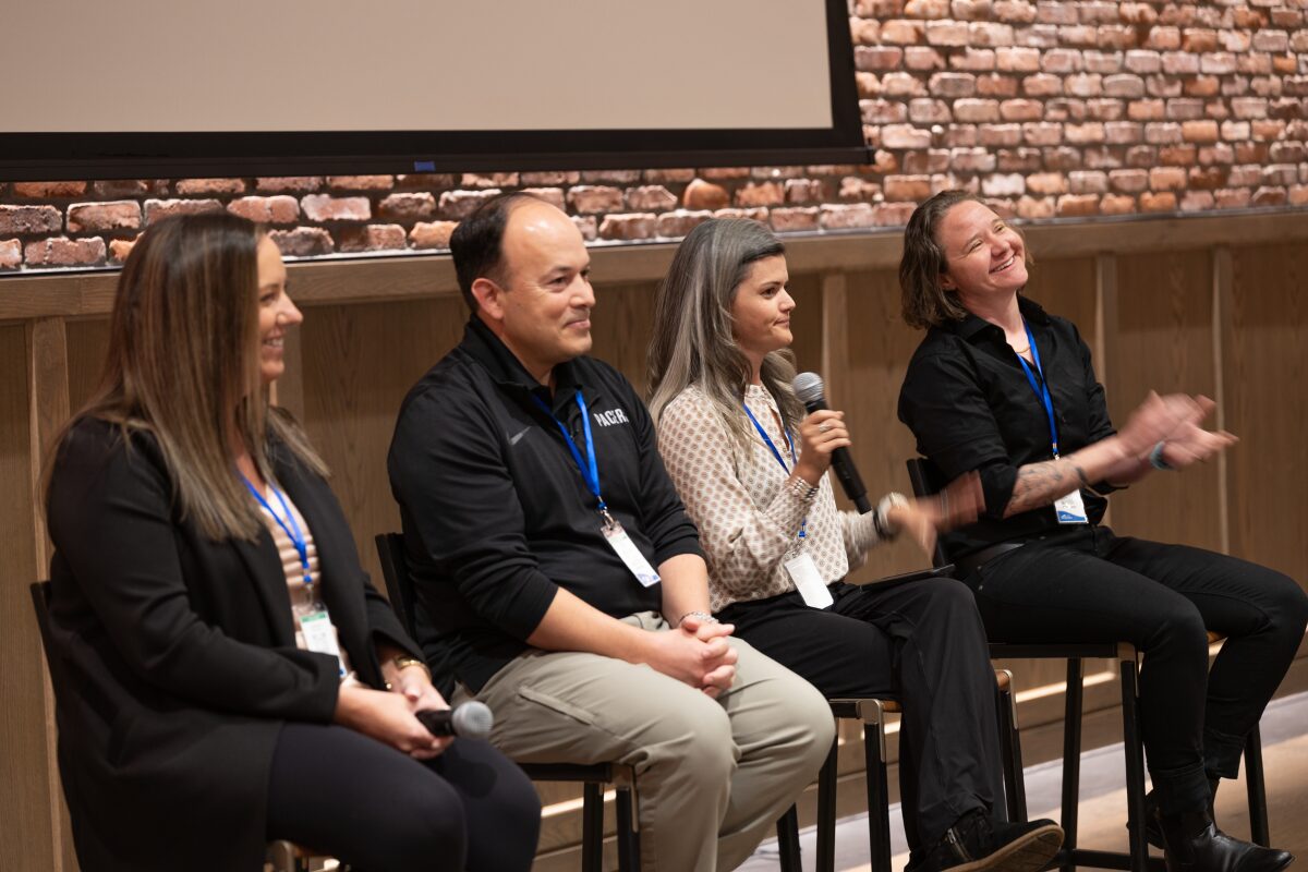 Four panelists speaking during the Customer Panel session at the 2025 rezStream Customer Success Conference, sharing insights on OTAs and guest behavior.