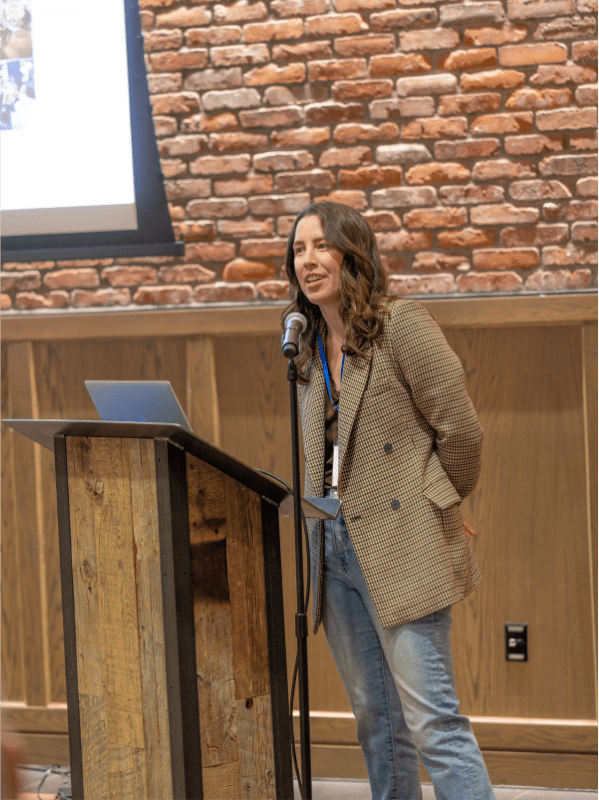 Hospitality photographer Stephanie Kelly presenting at the 2025 rezStream Customer Success Conference, sharing expert tips on hotel photography and visual storytelling.
