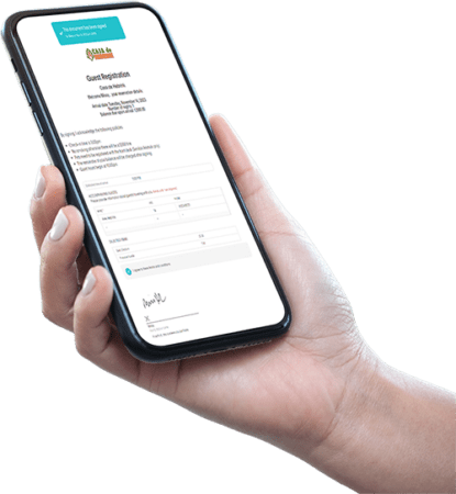 Hand holding a smartphone displaying a completed digital guest registration form with a signed confirmation message.