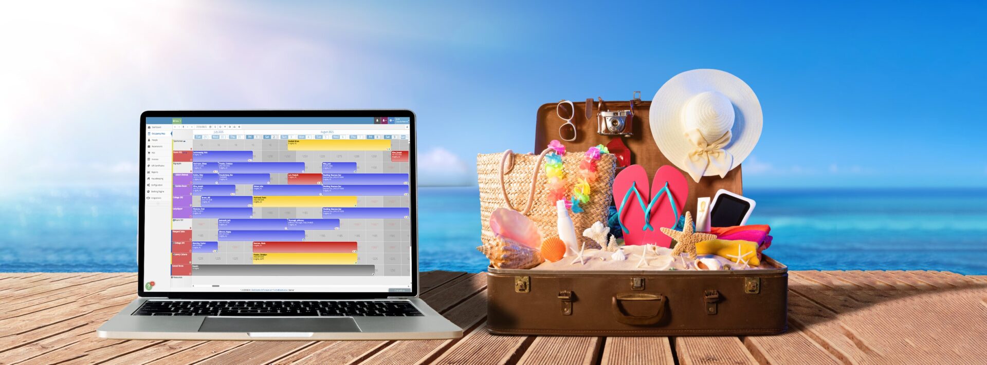 Laptop displaying a rezStream booking and scheduling calendar on a wooden deck beside an open suitcase filled with summer travel items, set against a bright ocean and blue sky background.