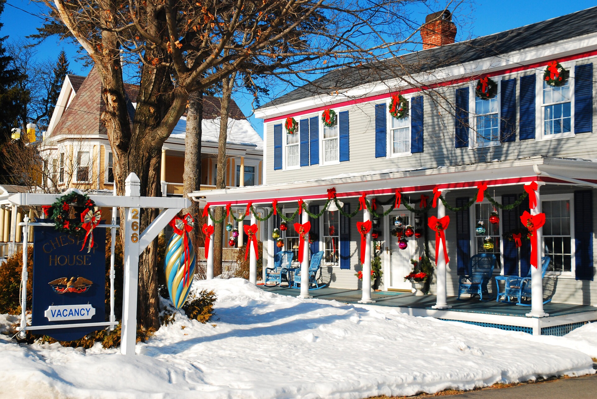Exterior of a small hotel adorned with Christmas decorations.