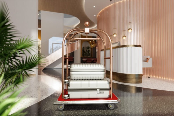 Luxury Hotel Entrance With Luggage Cart, Suitcases And Side View Of Reception Desk.