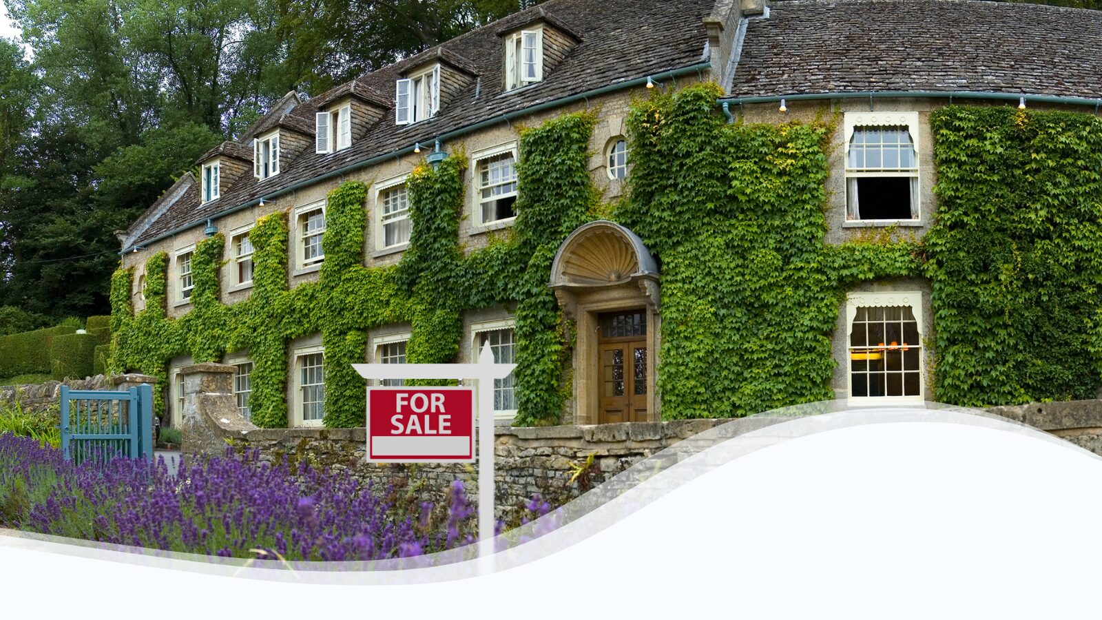 Image of a rustic inn with a "For Sale" sign in front.